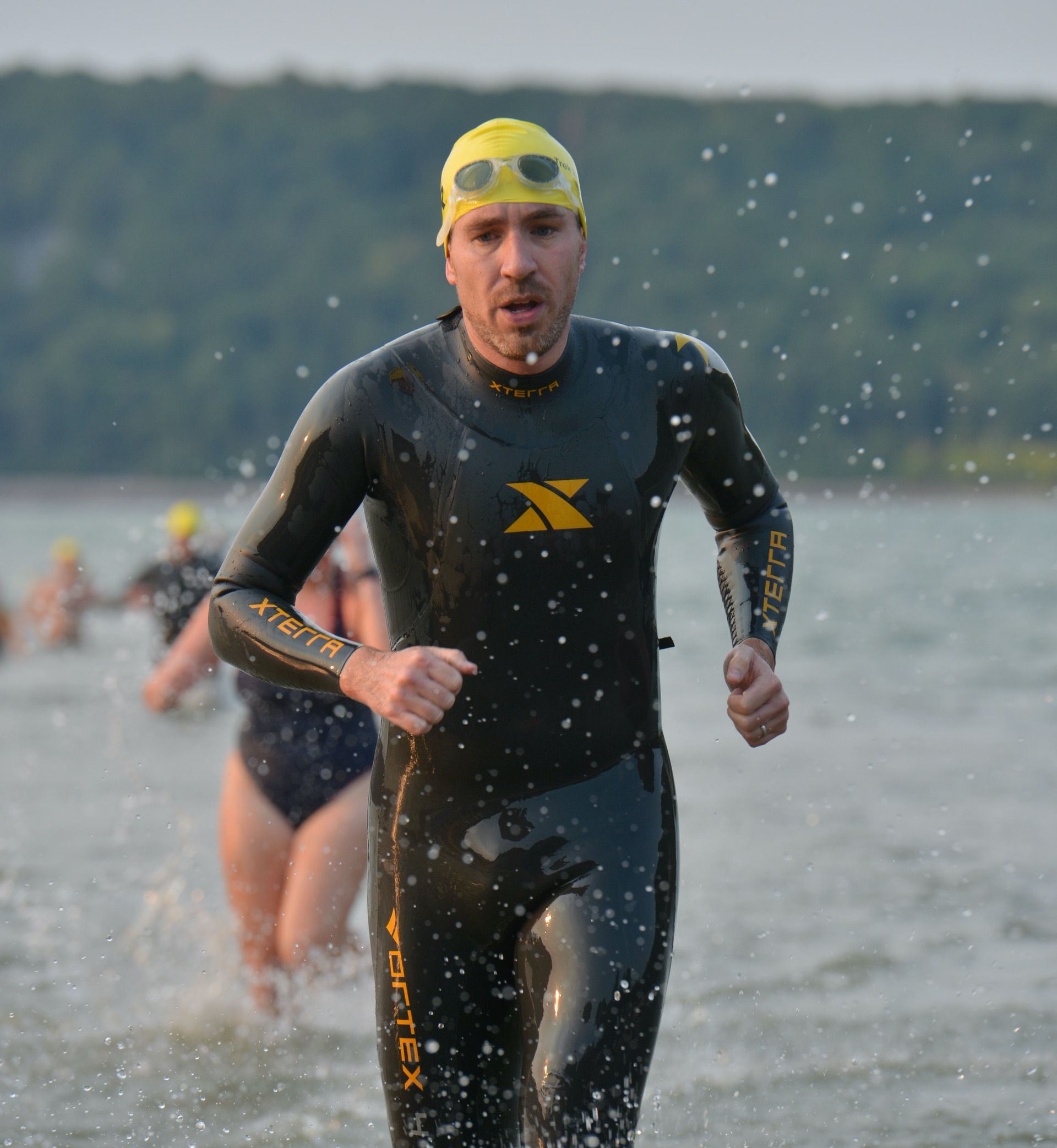 Jerry Potter in a wetsuit coming out of the water.